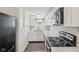 Bright kitchen features white cabinets, black appliances, and faux marble countertops at 4709 S County Road 500 E, Plainfield, IN 46168