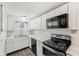 Well-lit kitchen featuring white cabinetry, sleek countertops, and modern appliances, creating a clean and functional space at 4709 S County Road 500 E, Plainfield, IN 46168