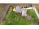 Aerial view of the house highlighting a beautiful backyard, a wooden deck, and a well-manicured lawn with mature trees at 4965 N 500 W, Columbus, IN 47201