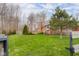 Expansive backyard featuring a spacious deck, lush green lawn, and mature trees, perfect for outdoor entertaining and relaxation at 4965 N 500 W, Columbus, IN 47201