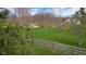 Scenic backyard view featuring a lush green lawn, mature trees, and a wooden fence, creating a serene and private outdoor space at 4965 N 500 W, Columbus, IN 47201