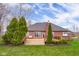Back exterior view of house with a wooden deck, enhanced by mature trees and meticulous landscaping, adding privacy at 4965 N 500 W, Columbus, IN 47201