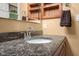 Close up of the granite countertop and cabinet inside the bathroom at 4965 N 500 W, Columbus, IN 47201