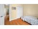 Bedroom boasts hardwood floors, closet, and a quilt covered bed in a bright and airy space at 4965 N 500 W, Columbus, IN 47201