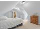 Charming bedroom features neutral carpet, dresser, and white door in an attic space at 4965 N 500 W, Columbus, IN 47201