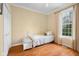 Bright bedroom featuring hardwood floors, natural light, and cozy quilt covered bed at 4965 N 500 W, Columbus, IN 47201