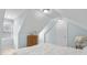 Attic bedroom featuring neutral carpet, dresser, and white door in a bright space at 4965 N 500 W, Columbus, IN 47201