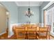 Formal dining room featuring a chandelier, large table with seating, and wainscoting detail at 4965 N 500 W, Columbus, IN 47201