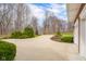 Long driveway leading to the house and garage, with a basketball hoop, enhanced by well-manicured landscaping at 4965 N 500 W, Columbus, IN 47201