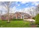 Charming two-story home features a brick and wood facade, landscaped yard, and a long, paved driveway at 4965 N 500 W, Columbus, IN 47201