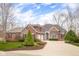 Charming two-story home features a brick and wood facade, landscaped yard, and a long, paved driveway at 4965 N 500 W, Columbus, IN 47201