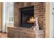 Close-up on the brick fireplace, featuring a hearth and decorative details, creating a warm and inviting ambiance at 4965 N 500 W, Columbus, IN 47201