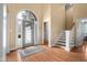 A bright foyer showcases hardwood floors and a staircase leading to the second floor and a door to the garage at 4965 N 500 W, Columbus, IN 47201