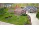 Charming home with a manicured front yard, lush landscaping, and a well-maintained driveway creating curb appeal at 4965 N 500 W, Columbus, IN 47201