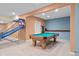 Finished basement game room featuring a pool table, basketball hoop game, and neutral carpeting at 4965 N 500 W, Columbus, IN 47201