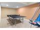 Finished basement game room featuring a ping pong table, basketball hoop game, and neutral carpeting at 4965 N 500 W, Columbus, IN 47201
