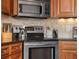 Well-appointed kitchen with stainless steel appliances, including a range and microwave, complemented by stylish cabinetry at 4965 N 500 W, Columbus, IN 47201