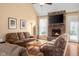 Comfortable living room features a brick fireplace, hardwood floors, and cozy furniture, ideal for relaxing and entertaining at 4965 N 500 W, Columbus, IN 47201