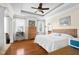 Spacious main bedroom featuring tray ceilings, hardwood floors, and natural light from two large windows at 4965 N 500 W, Columbus, IN 47201