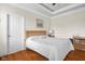 This bedroom features a bed with a white comforter, wood floors, and plenty of natural light from a window at 4965 N 500 W, Columbus, IN 47201