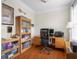 Office space with wood floors, built-in shelves, and a wooden desk with a computer at 4965 N 500 W, Columbus, IN 47201