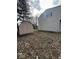 Backyard with a shed on a partially grass and leaves-covered ground at 5155 Overland Ct, Indianapolis, IN 46268