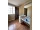 Bathroom features a mirror, window, and a marble countertop vanity and laminate floor at 5155 Overland Ct, Indianapolis, IN 46268
