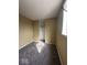 A carpeted bedroom featuring tan painted walls and a closet area with installed hanging rod at 5155 Overland Ct, Indianapolis, IN 46268