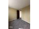 This carpeted bedroom has tan painted walls and a closet area at 5155 Overland Ct, Indianapolis, IN 46268