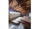Large garage with exposed wood framing, door, and plenty of space for parking and storage at 5155 Overland Ct, Indianapolis, IN 46268