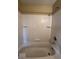 Clean tub and shower combination with neutral tile, perfect for relaxation and easy maintenance at 5155 Overland Ct, Indianapolis, IN 46268