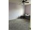 A serene carpeted bedroom with soft lighting and a ceiling fan provides a cozy and relaxing atmosphere at 5832 Cabot Dr, Indianapolis, IN 46221