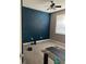 Bedroom featuring a painted accent wall and modern ceiling fan at 5832 Cabot Dr, Indianapolis, IN 46221