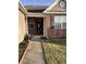 A welcoming covered entrance features a charming brick facade with space for planting flowers and greenery at 5832 Cabot Dr, Indianapolis, IN 46221