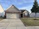 Charming single-Gathering home boasts brick accents, a two-car garage, and a well-maintained front lawn at 5832 Cabot Dr, Indianapolis, IN 46221