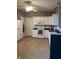 The ample kitchen has white cabinets, modern appliances, tile flooring, and plentiful countertop space at 5832 Cabot Dr, Indianapolis, IN 46221