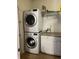 Laundry room features a stacked washer and dryer with shelving at 5832 Cabot Dr, Indianapolis, IN 46221
