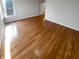 Clean, empty bedroom with hardwood floors, a window with natural light and fresh white walls at 6232 Behner Xing, Indianapolis, IN 46250