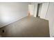 Neutral bedroom featuring plush carpet, a closet, and an open doorway leading to a hallway at 6232 Behner Xing, Indianapolis, IN 46250