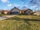 Charming single-story home featuring a well-manicured front yard and attached garage, with blue sky at 6232 Behner Xing, Indianapolis, IN 46250
