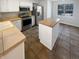 Well-lit kitchen features stainless steel appliances, a center island, and tile flooring throughout at 6232 Behner Xing, Indianapolis, IN 46250