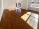 Sun-filled living room boasting gleaming hardwood floors and multiple windows, creating a bright and airy atmosphere at 6232 Behner Xing, Indianapolis, IN 46250