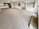 Spacious living area with carpet, open to the kitchen, with visible stone fireplace at 6232 Behner Xing, Indianapolis, IN 46250
