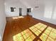 Spacious living room featuring gleaming hardwood floors and lots of natural light from multiple windows at 6232 Behner Xing, Indianapolis, IN 46250