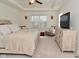 Serene bedroom with a decorative bedframe, tray ceiling, ceiling fan and modern furnishings at 655 Bracknell Dr, Avon, IN 46123