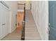 Elegant foyer with a carpeted staircase, wood railing, and view of the second floor landing at 655 Bracknell Dr, Avon, IN 46123