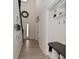 Hallway with coat rack and storage bench leading to the front door and staircase at 655 Bracknell Dr, Avon, IN 46123