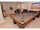 Spacious game room featuring a pool table, comfortable seating, and sports-themed decor, perfect for entertaining at 655 Bracknell Dr, Avon, IN 46123