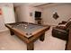 Inviting game room with a pool table, cozy recliner seating, and a TV, ideal for relaxation and entertainment at 655 Bracknell Dr, Avon, IN 46123