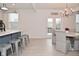 Open-concept kitchen with bar seating, dining area, and access to an outdoor patio at 655 Bracknell Dr, Avon, IN 46123